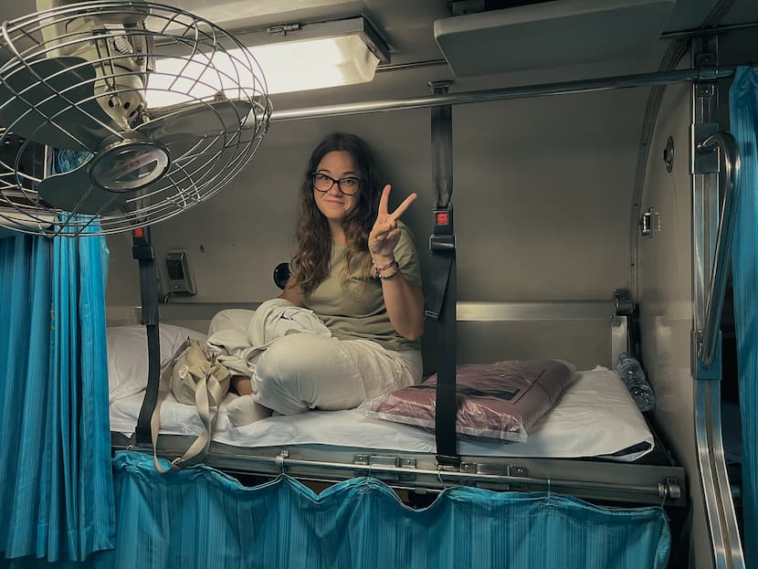 Inma en la cama del tren nocturno de camino a Bangkok, una opción genial para ahorrar en tu presupuesto de viaje a Tailandia